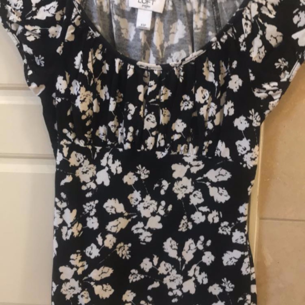 Black and white cap sleeve top with empire waist.